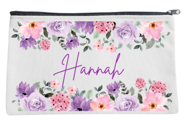 Three personalized pouches with A name written on them, adorned with different floral designs.