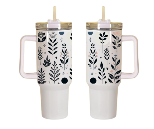 Two white travel mugs with botanical prints and beige lids, equipped with straws and handles. 40 oz tumbler like Stanley