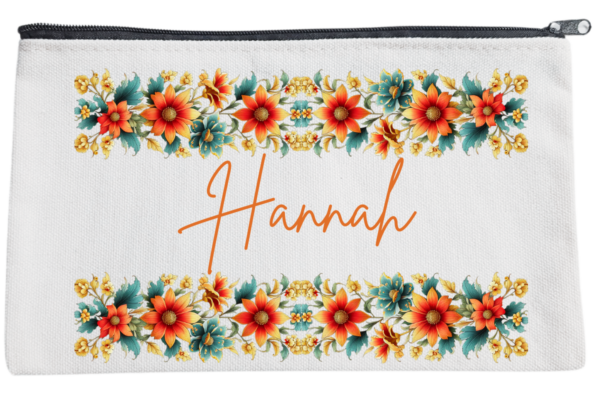 Three personalized pouches with A name written on them, adorned with different floral designs.