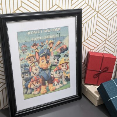 Framed Paw Patrol wooden puzzle keepsake displayed against a patterned wall.